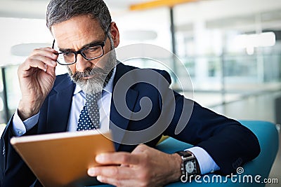 Business, technology and people concept - senior businessman with tablet pc working in office Stock Photo