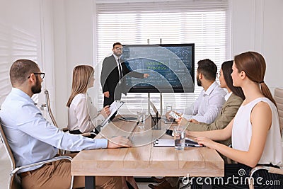 Business trainer using interactive board in meeting room during presentation Stock Photo