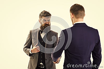 Business transactions. Men in classic suits, businessmen, business partners meeting, white background, Stock Photo