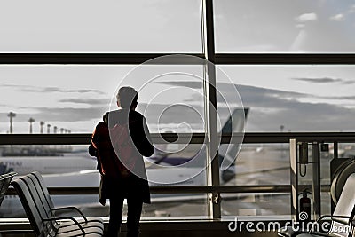 Business travel concept with silhouette man standing at gate in airport Editorial Stock Photo