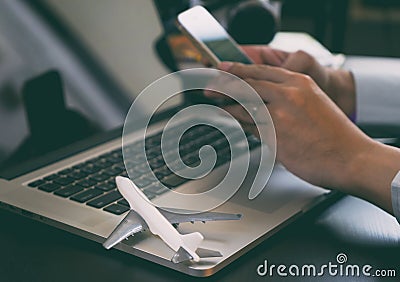 Business traveler using phone to book his trip Stock Photo