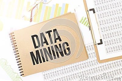 Business up graph on a sheet of craft colour Notepad with DATA MINING sign. Notepad on desk with financial documentation Stock Photo