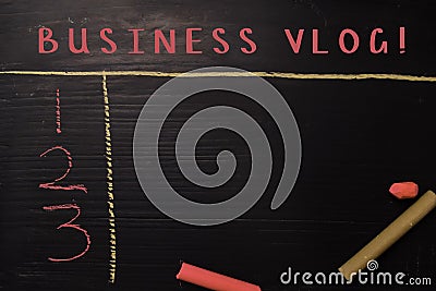 Business Vlog! written with color chalk. Supported by an additional services. Blackboard concept Stock Photo