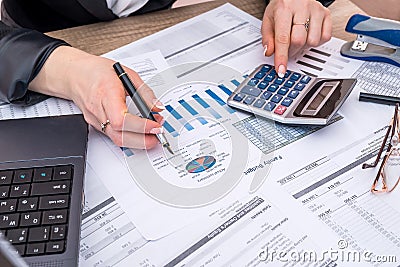 Business woman account annual budget with laptop, pen Stock Photo