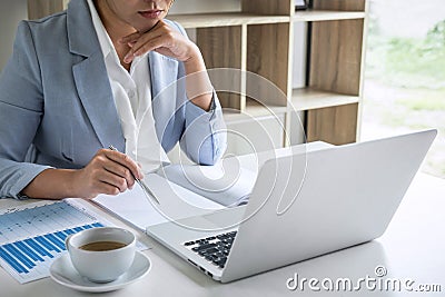 Business woman accountant financier working audit and calculating expense financial annual report balance sheet statement, doing Stock Photo