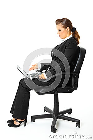 Business woman amazedly looks in laptops screen Stock Photo