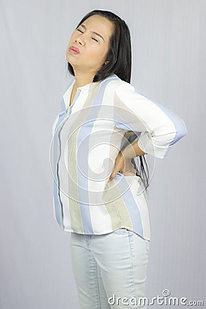Business woman with back pain, suffering from back pain isolated on gray background Stock Photo