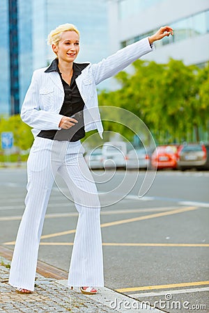 Business woman catching taxi near office center Stock Photo
