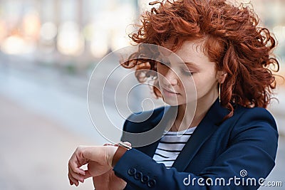 Business, woman in city and check time outdoor, travel and schedule for project, deadline and waiting. Female employee Stock Photo
