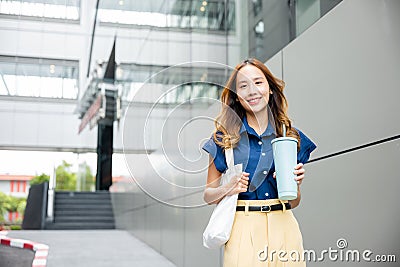 business woman confident smiling with cloth bag holding steel thermos tumbler Stock Photo