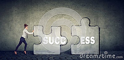 Business woman connecting elements of success puzzle Stock Photo