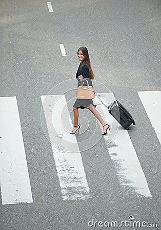 Business woman crossing at zebra crossway Stock Photo