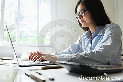 business woman doing accounting and finance on laptop in office Stock Photo