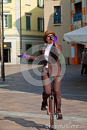 Business woman drink a coffee on the unicycle Stock Photo