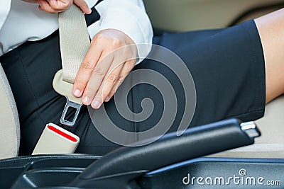 Business woman fastening seat belt in car before driving. Stock Photo