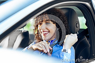 Business woman fastening seat belt in car. Stock Photo