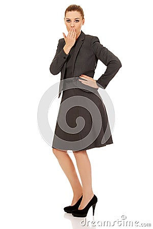 Business woman giggles covering her mouth with hand Stock Photo