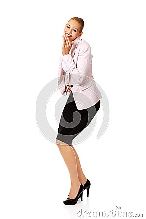 Business woman giggles covering her mouth with hand Stock Photo