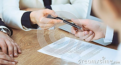 Business woman giving pen to businessman ready to sign contract. Success communication at meeting or negotiation Stock Photo