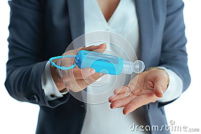 Business woman in grey suit on disinfecting hands Stock Photo