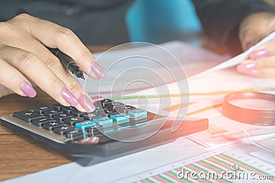 business woman hand calculating her monthly expenses during tax season Stock Photo