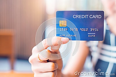 Business woman hand holds a blue credit card Stock Photo