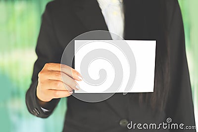 Business woman hand mockup holding blank sheet of paper office working - young woman in suit shows white card Area for advertising Stock Photo