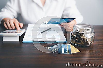 Business woman hands holding saving account passbook with calculator, account and saving concept. Asian woman checking bills, Stock Photo