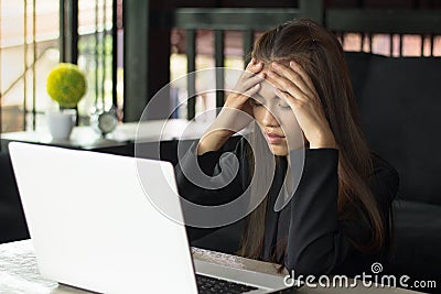 Business Woman Having Headache While Working Using Laptop Computer. Stressed And Depressed Girl Touching Her Head, Work Failure Stock Photo