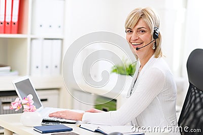 Business woman with headset working at office Stock Photo