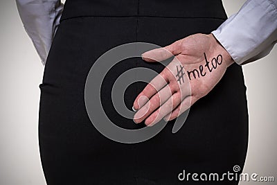 Business woman hiding behind her back a palm with an inscription me too. Stop sexual harassment against women. metoo concept Stock Photo