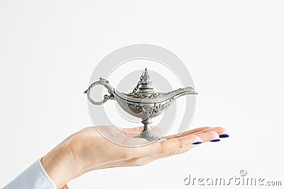 Business woman holding genie lamp waiting for a miracle Stock Photo