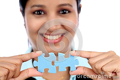 Business woman joining two jigsaw puzzle pieces Stock Photo