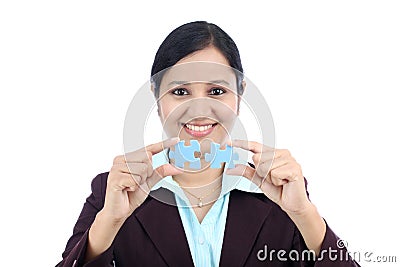 Business woman joining two jigsaw puzzle pieces Stock Photo