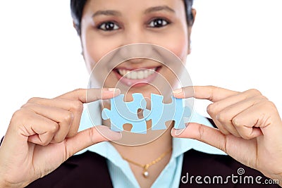 Business woman joining two jigsaw puzzle pieces Stock Photo