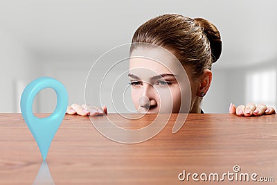 Business woman looking on gps pointer under the edge of table. Stock Photo