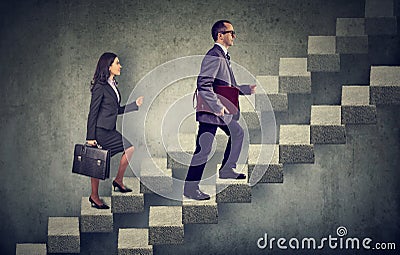 Business woman and man with briefcase stepping up a stairway career ladder Stock Photo