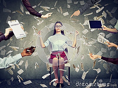 Business woman is meditating to relieve stress of busy corporate life under money rain Stock Photo