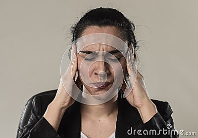 Business woman in office suit suffering migraine pain and strong headache Stock Photo