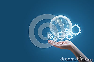 Business woman in the palm of your hand keeps the watch and the gears symbolizes the process of a successful business Stock Photo