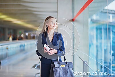 Business woman with passport and boarding pass in international airport Stock Photo