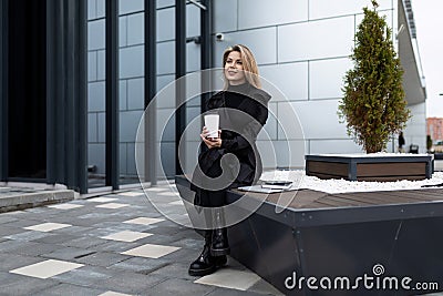 business woman pause coffee next to office building Stock Photo