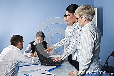 Business woman pointing to laptop at meeting Stock Photo