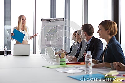 Business woman presenting project to her colleagues Stock Photo