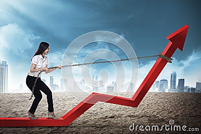 Business Woman Pulling Arrow With Chain Stock Photo