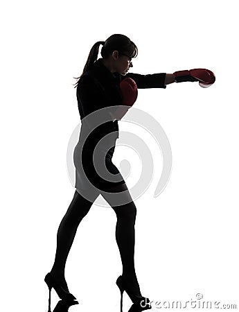 Business woman punching boxing gloves silhouette Stock Photo