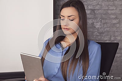 Business woman reads the news on the tablet Stock Photo