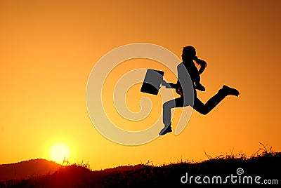 Business woman runing and sunset silhouette Stock Photo