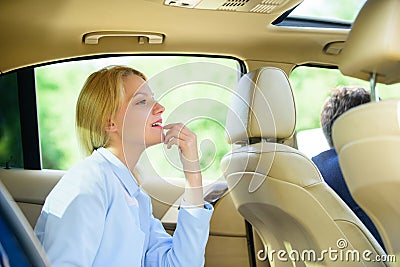 Business woman sit on backseat. Busy lady passenger leather car salon enjoy journey with chauffeur. Business lady Stock Photo