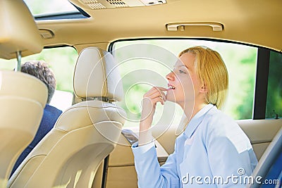 Business woman sit on backseat. Busy lady passenger leather car salon enjoy journey with chauffeur. Business lady Stock Photo